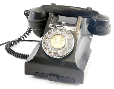 A vintage telephone, in black with cord receiver and chrome front dial with front drawer, 17cm high.(AF)