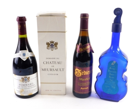 A bottle of Merlot Aurm, a bottle of Domaine Du Chateau De Meursault, (boxed) and an empty bottle of Mursterer 1998 in blue violin shaped bottle.