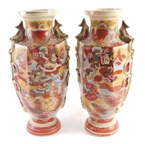 A pair of Japanese Satsuma pottery vases, typically decorated with figures and flowers in orange and brown with gilt highlights, 46cm high. (2)