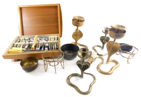 Various metalware, a pair of cobra candlesticks, 29cm high, another pair similar, various Eastern bowls, and a part canteen of cutlery, in part teak canteen. (a quantity)