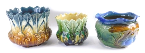 A 20thC majolica floral shaped pottery jardiniere, 21cm high, and other smaller similarly decorated, and a further majolica jardiniere. (3)