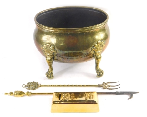 An early 20thC brass planter, with acanthus capped hairy paw feet, 30cm high, 38cm wide, 27cm deep, a toasting fork, poker and a faux gold bar money box.