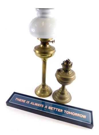 An early 20thC brass oil lamp, with milk class shade on fluted stem, 58cm high, another oil lamp and wall plaque There is Always a Better Tomorrow .