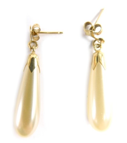 A pair of 9ct gold cultured pearl drop earrings, each with tear drop pendant, with a shaped fleur de lis stud, on single pin back, with butterfly backs, 3cm high, 2.7g all in.