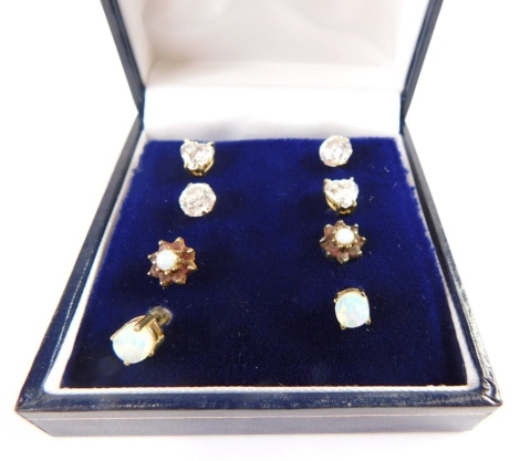 A group of 9ct gold and other earrings, comprising a pair of 9ct gold opal studs, with single opal in basket setting, a pair of floral cluster studs set with garnets and opal, and two pairs of yellow metal and white stone set studs, 4.4g all in. (4 pairs)