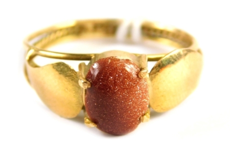 A dress ring, set with an orange glittered man made gem stone, in a four claw basket setting with leaf vine shoulders and twist design band, yellow metal unmarked, ring size P½, 2.8g all in.