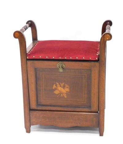 An Edwardian mahogany piano stool, with scroll arms, central seat and front hinged opening, inlaid with vase and musical instruments, with a boxwood stringing and satinwood inlay, on block stiles, 63cm high, 57cm wide, 37cm deep.