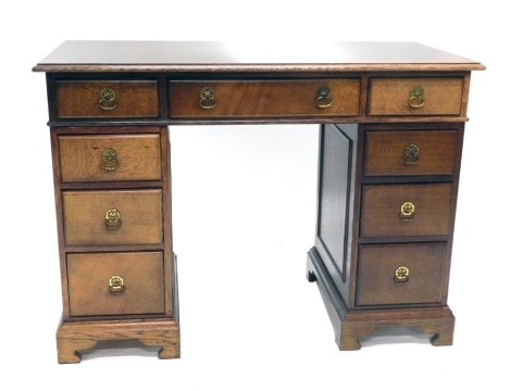 A 20thC oak twin pedestal desk, with three frieze drawers, raised above six pedestal drawers, on bracket feet, 76cm high, 107cm wide, 51cm deep.