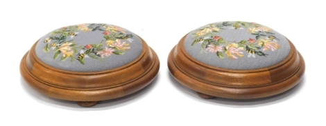 A pair of early 20thC petit point Waring & Gillows stools, of circular form on squat circular feet, overstuffed and decorated with bees and leaves, 41cm diameter. (2)