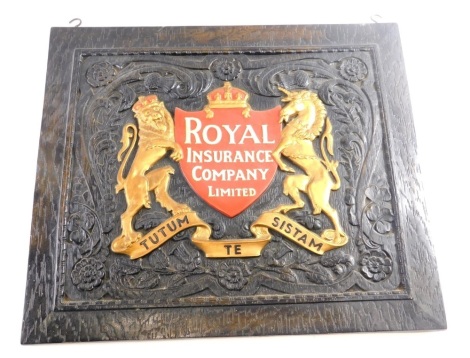 A mid 20thC oak backed Royal Insurance Company Ltd sign, with hooks to the top, raised with gilt Lion and Unicorn, with red shield and white lettering on a heavily carved scroll and floral ground. 47cm x 55cm.