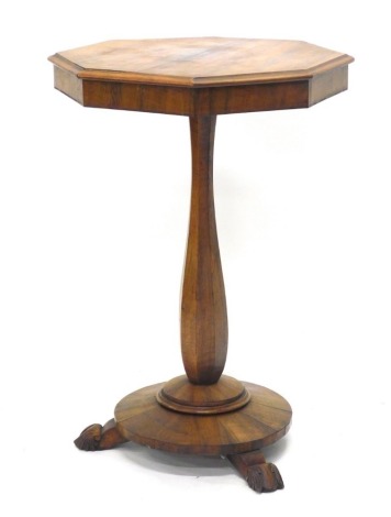 A 19thC walnut occasional table, with octagonal figured top, on a baluster shaped faceted column, and circular platform, with leaf carved feet, 75cm high, 51cm wide.