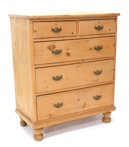 A Victorian pine chest of drawers, the top with rounded corner, above two short and three long drawers on bun feet, 108cm high, 92cm wide.