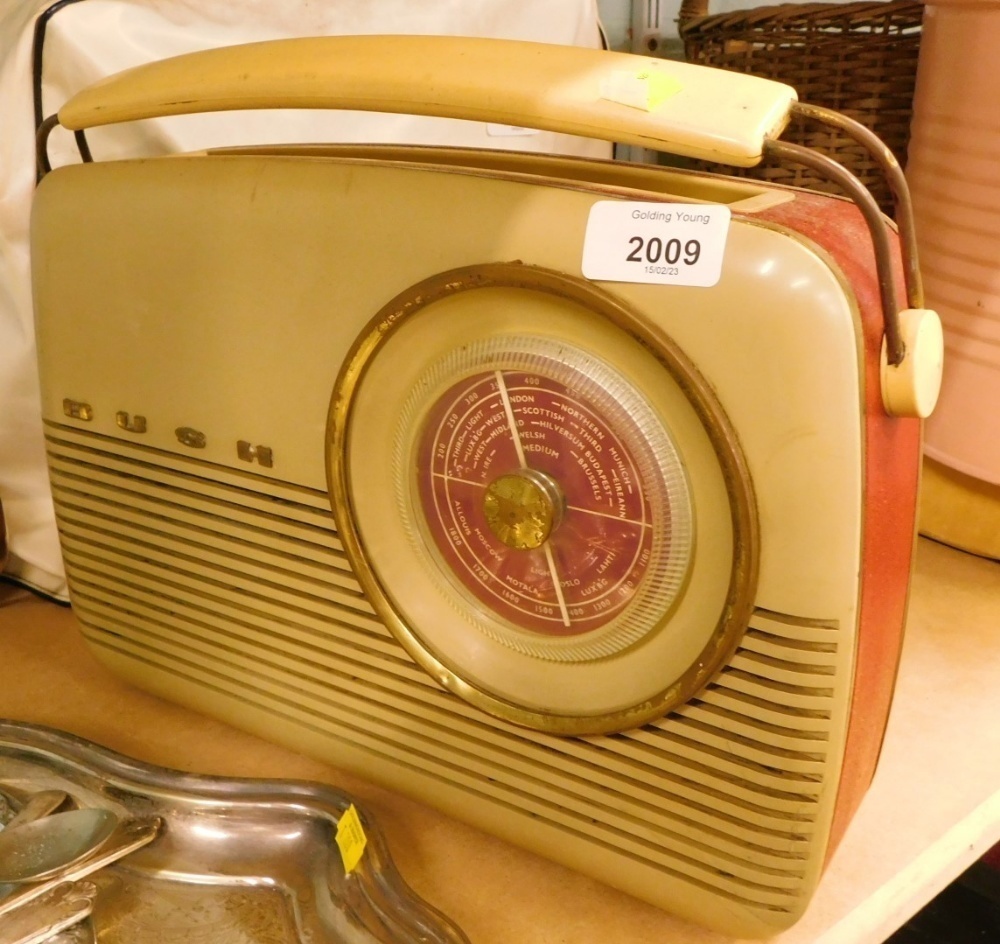 A vintage Bush radio, in red and cream, with swing handle, number