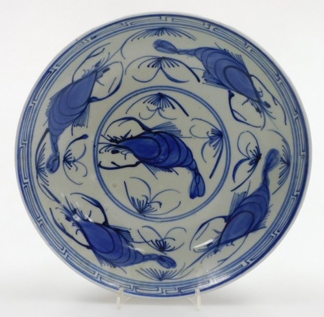 A Japanese blue and white dish, hand painted with shrimps, under glaze blue mark to underside, 24cm diameter.