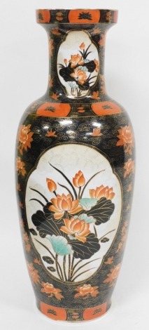 A Chinese famille noir porcelain baluster vase, painted with floral designs in iron red, black and gilt, red seal mark to underside, 90cm high.