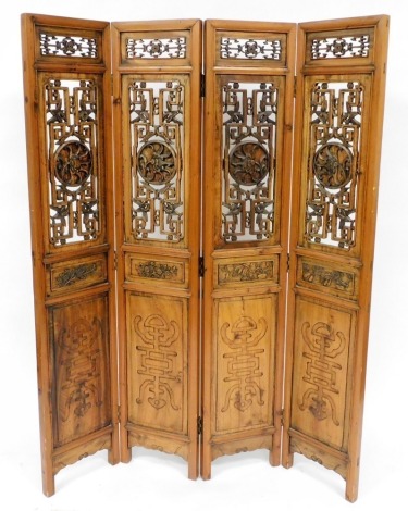 A Chinese pine four fold screen, with carved and pierced panels and Chinese character carvings, 170cm high, 128cm wide.