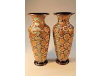 A pair of large Royal Doulton baluster vases decorated with impressed and gilded flowers