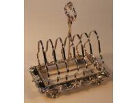 A late Victorian silver toast rack in the rococo manner