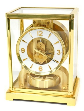 A 20thC Jaeger- LeCoultre VIII Atmos clock, with gilt metal movement, annular tension pendulum mechanism, 10cm diameter white chapter ring with applied dagger and Arabic numerals, within a brushed gilt brass and glass case, 24cm high.