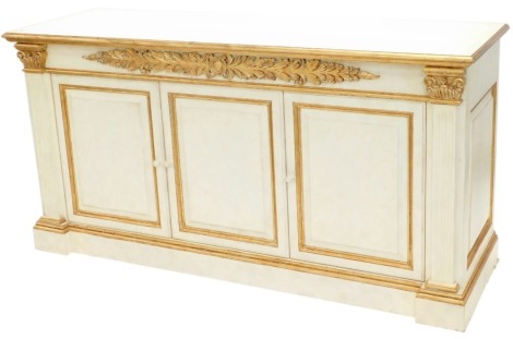 An associated suite of dining furniture, originally purchased for Harrods, comprising a continental cream and gilt painted side cabinet, the top with a moulded edge above a plain frieze applied with acanthus carving and three panelled doors each flanked b