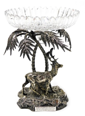 A 19thC silver plated centrepiece modelled as a stag standing beneath two palm trees, with a circular cut glass bowl, the base presentation engraved 'Hector Fraser From a Few Ship Mates in SS Gleneagles 2nd September 1884,' 25.5cm high.