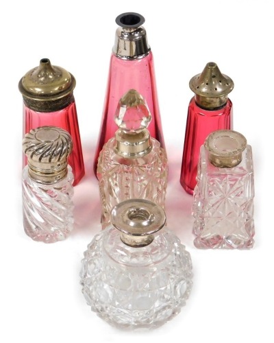 A group of Victorian and later glass and silver mounted scent bottles, to include a Victorian scent bottle of cylindrical twisted form, Chester 1894, 7cm high, lacking stopper, scent bottle of globular form, etc., together with a cranberry coloured glass