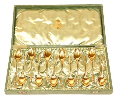 A set of twelve Swedish gilt metal coffee spoons, each handle cast with a hoof terminal and with a turned stem, 3.89oz, in a fitted box stamped GG Hallberg, Stockholm, Goteborg.