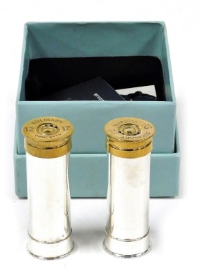 A pair of Culinary Concepts salt and pepper shakers modelled as gun cartridges, silver plated with a brass mount, boxed.