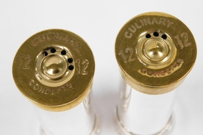 A pair of Culinary Concepts salt and pepper shakers modelled as gun cartridges, silver plated with a brass mount, boxed. - 2