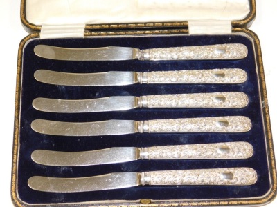 A set of six Edward VII silver handled cake knives, each handle with embossed floral and scroll decoration, stainless steel blades, Sheffield 1902, in fitted case, together with a set of six George V silver handled fruit knives, Sheffield 1934, each in a - 2