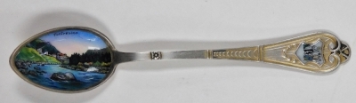 A group of small silver and white metal items, comprising a Continental white metal handled carving knife and fork, embossed with scrolls and flowers, marked 800, four commemorative enamel silver teaspoons, for Canada, Limerick, Pontresina and The Royal A - 5