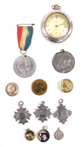 A Waltham gentleman's pocket watch, open faced, keyless wind, circular dial bearing Roman numerals, subsidiary seconds dial, the white metal case of plain form, with outer case, together with three silver medallions, two engraved St Thomas N. School, 1901