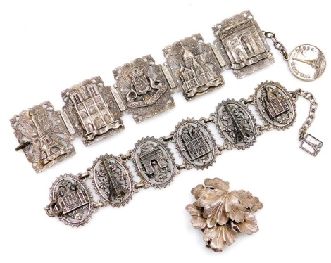 Two 20thC French Souvenir de Paris bracelets, white metal, embossed with the sights of the city, together with an early 20thC A-F Paris double leaf form clip brooch. (3)