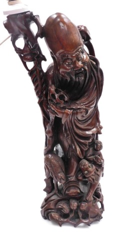 A Chinese hardwood carving of Shao Lao, converted to a table lamp, 62cm high overall.