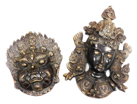 Two brass Buddhist wall masks, comprising a Mahakala, 13.5cm high, and a Tara goddess, 20cm high.