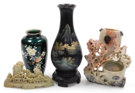 A group of Oriental items, comprising a Japanese enamel vase of cylindrical tapering form, decorated with a flowering tree on a green ground, 16cm high, a soapstone vase, 18cm high, a soapstone carving, 9cm high, and a lacquer vase decorated in gilt with 