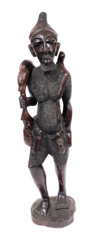 An African hardwood carving of a warrior, 108cm high