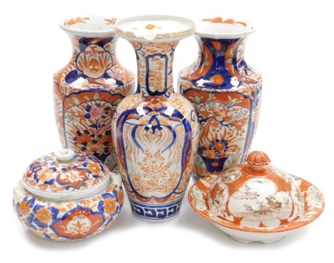 Three Japanese Imari vases, 24cm high (2) and 26cm high, together with an Imari circular jar and cover and a Japanese bowl and cover with iron red and gilt decoration, (5).