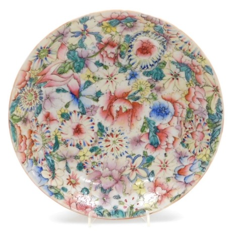 A Chinese famille rose dish, decorated profusely with flowers and coloured enamels, six character Qianlong mark to underside, 24cm diameter