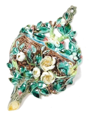 A late 19thC majolica wall pocket, moulded with a nest, flowers and leaves and encrusted with further flowers, 25cm high.