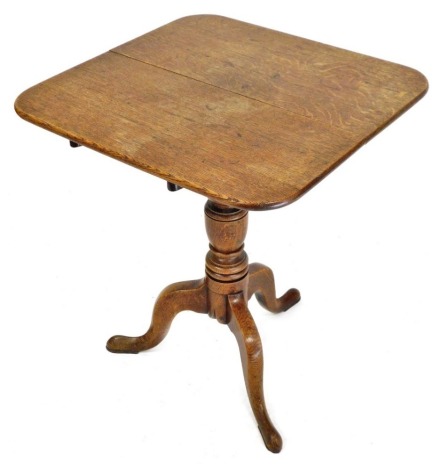 A George III oak tilt top occasional table, the square top with a rounded edge above a turned column raised on three cabriole legs, 71cm high, the top 56cm x 60cm.