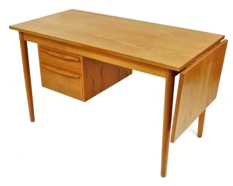 A Danish teak desk, probably Ejsing Mobelfabrik, the rectangular top above two side drawers, with a further drop leaf to one side, raised on cylindrical tapering legs, 70cm high, 121cm, 60cm deep, additional leaf 40cm wide.