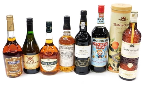 A group of alcohol, comprising a bottle of Martell cognac, Southern Comfort, Napoleon brandy, Three Barrels brandy, Dow's port, Woods Old Navy rum, and Grande Cuvee Mandarin Napoleon liqueur.