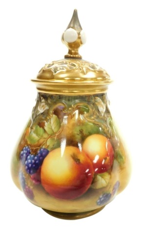 A Royal Worcester porcelain vase and pierced cover, circa 1951, the body painted with fruit, signed J Smith, gilt heightened, pattern number 291, printed marks, 16.5cm high.