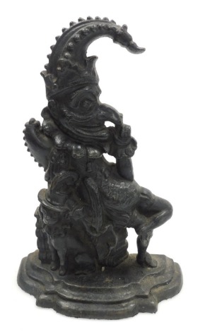 A Victorian cast iron doorstop, modelled in the form of Mr Punch seated beside Toby, 34cm high.