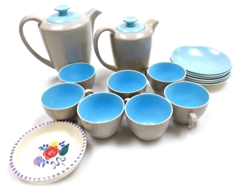 A Poole pottery part coffee service, in twin tone grey and pale blue, comprising coffee pot, hot water jug, six saucers and seven coffee cups, together with a Poole pottery pin dish, decorated centrally with flowers, 10.5cm diameter.