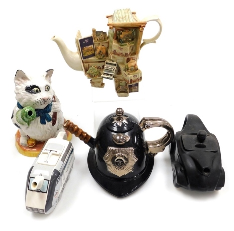 Five novelty pottery teapots, comprising a Saddlers type matt black car, 45cm wide, a Swineside tea pottery teapot in the form of a police helmet, a Le Shuttle teapot commissioned by the Euro Tunnel, a Lilliput Lane teapot, and a teapot modelled as a cat.