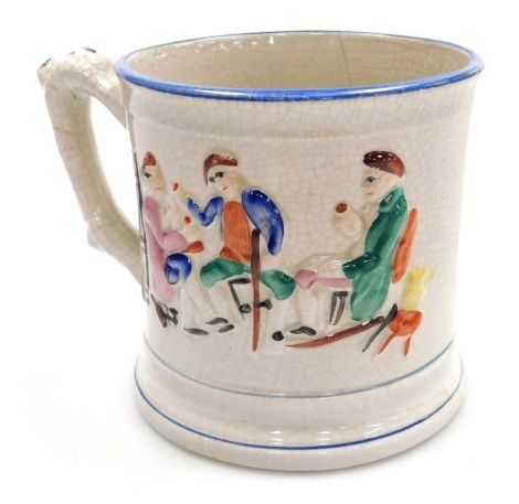 A 19thC Staffordshire pottery frog mug, the body decorated in relief with a drinking scene, with blue banding, 13cm high.