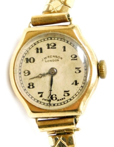 A JW Benson of London 9ct gold cased lady's wristwatch, circular silvered dial bearing Arabic numerals, on a plated strap.