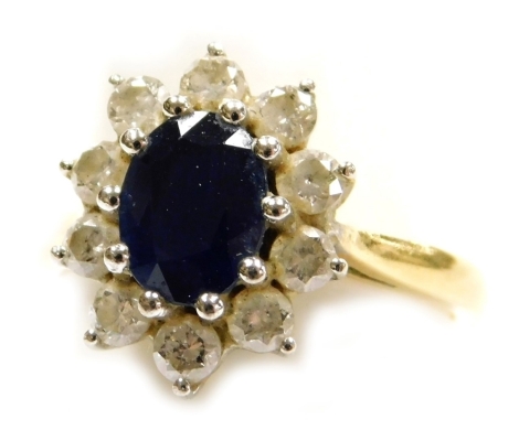 An 18ct gold sapphire and diamond flower head ring, in a basket setting, diamonds approximately 0.4cts, size O, 5.0g.